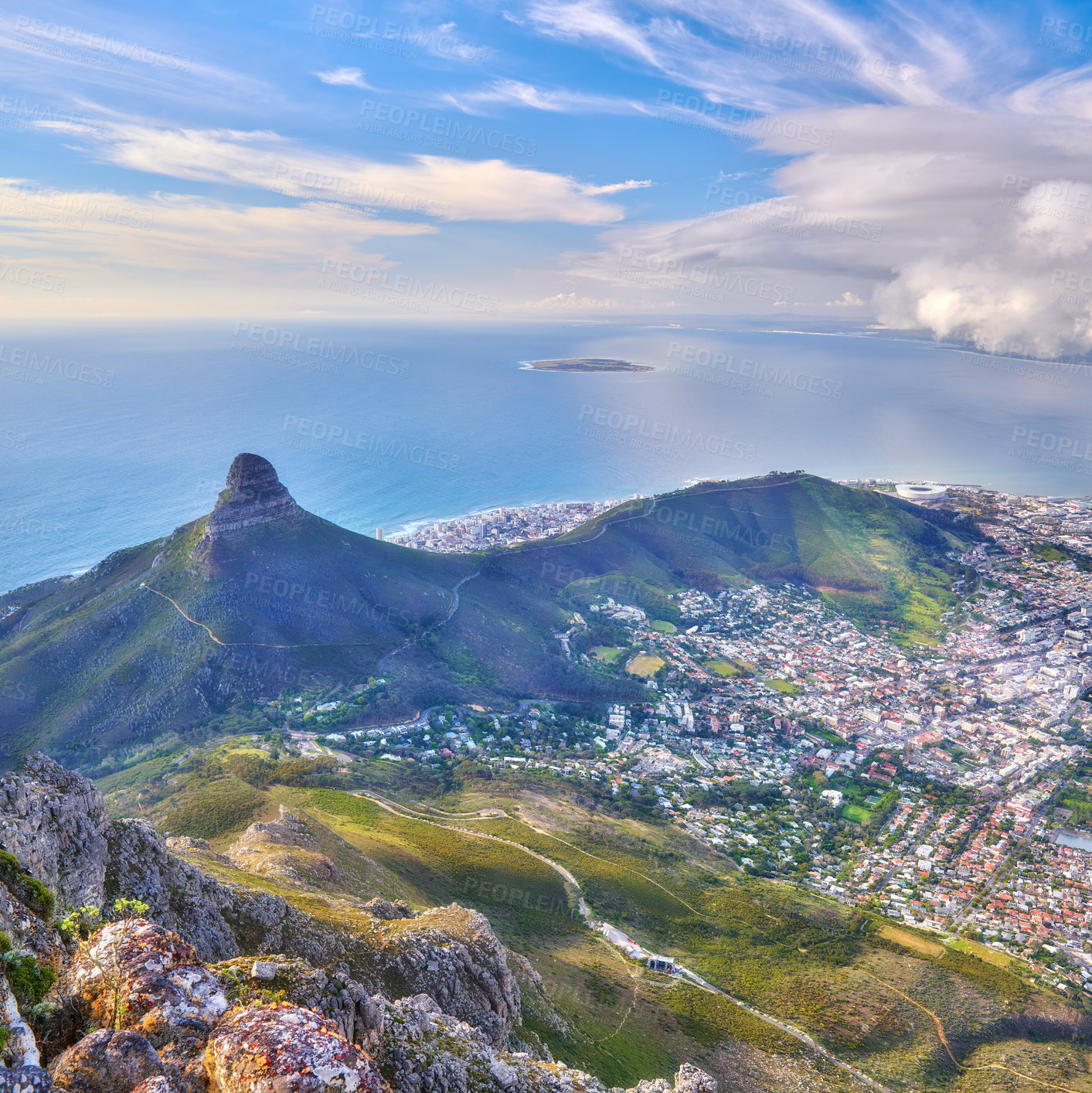 Buy stock photo Aerial landscape view of Lion's Head and surroundings in Cape Town, South Africa. Scenic natural landmark of a popular mountain against a cloudy blue sky in a beautiful urban city from above
