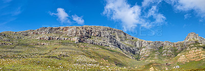 Buy stock photo Widescreen landscape view of Table Mountain in Cape Town, South Africa. Low panoramic scenery of a popular natural landmark and tourist attraction during the day against a blue cloudy sky in summer