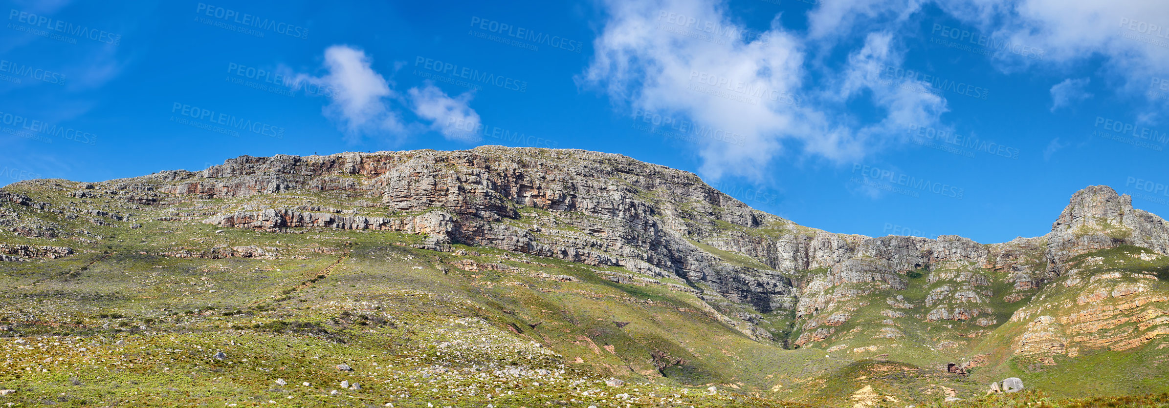 Buy stock photo Widescreen landscape view of Table Mountain in Cape Town, South Africa. Low panoramic scenery of a popular natural landmark and tourist attraction during the day against a blue cloudy sky in summer