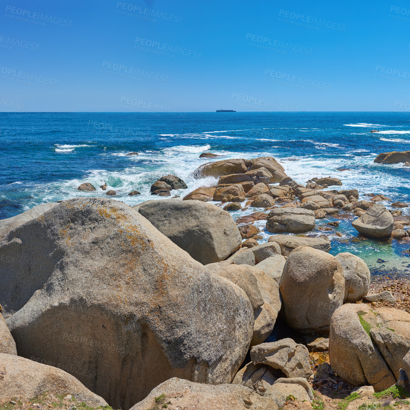 Buy stock photo Beautiful seascape beach waves splashing against boulders or big stones in aqua sea water. A summer nature location in South Africa. Rocks in the ocean under a blue sky background with copy space.