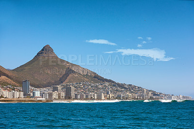 Buy stock photo Coastal view of Cape Town and mountain landscape on a sunny day. View of the ocean and city against a blue horizon. A popular travel destination for tourists and hikers, in Lion's Head, South Africa