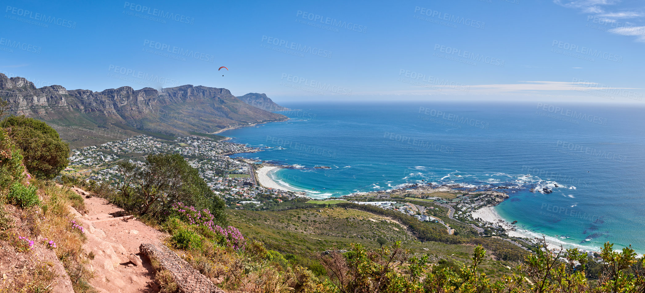 Buy stock photo Scenic hiking trail along Table Mountain with beautiful views of a coastal city against a blue sky background. Magnificent panoramic of peaceful and rugged landscape at the sea to explore and travel