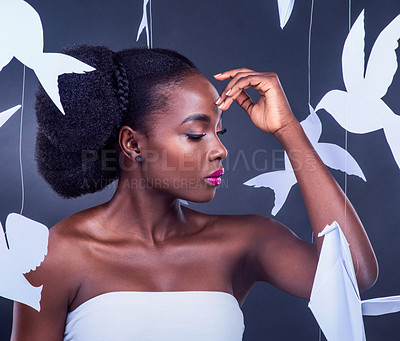 Buy stock photo Black woman, makeup and paper birds in studio on grey background for creativity, beauty and cosmetics. Female person, elegant and comfortable or satisfied with fashion, glamour and skin glow