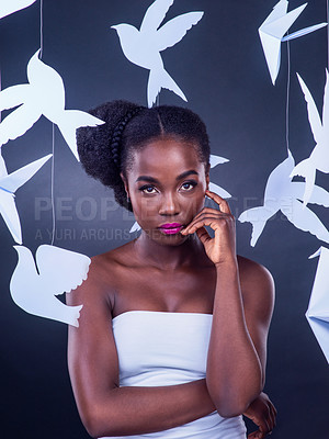 Buy stock photo African woman, portrait and creative beauty with fashion, art and confidence or empowerment with paper birds. Black girl, designer and makeup with origami for decor, design and cultural diversity