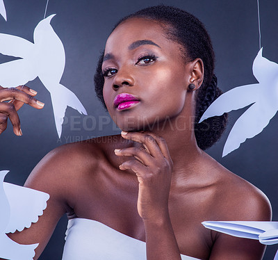 Buy stock photo Black woman, paper bird and portrait for freedom, peace and wellness isolated in dark background. African model, cosmetics and abstract fantasy for makeup, skincare and creative animal art or origami