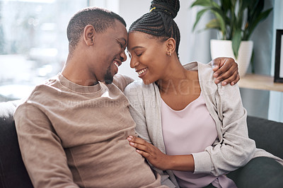 Buy stock photo Relax, love couple on a sofa, happy and smile while embracing, talking and laughing in their home. Black couple, man and woman hug on a couch, enjoy relationship, conversation and living room moment