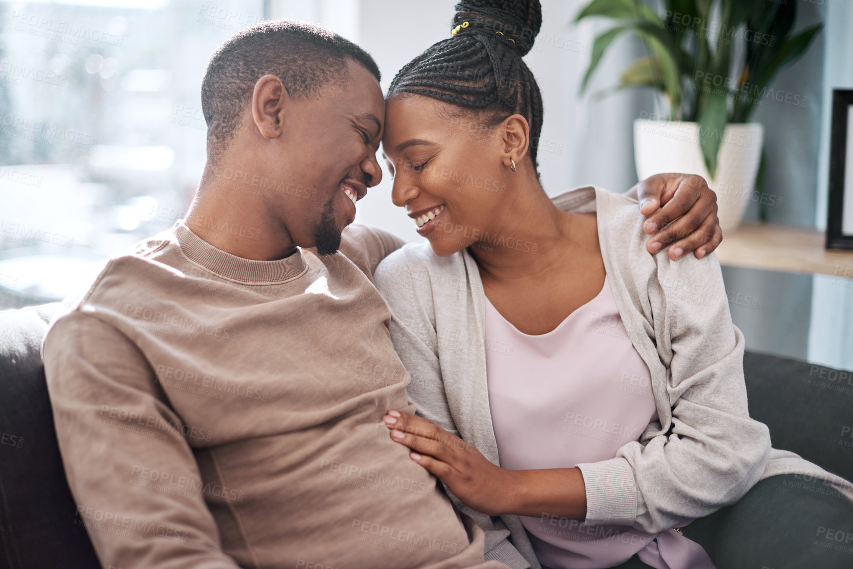 Buy stock photo Relax, love couple on a sofa, happy and smile while embracing, talking and laughing in their home. Black couple, man and woman hug on a couch, enjoy relationship, conversation and living room moment