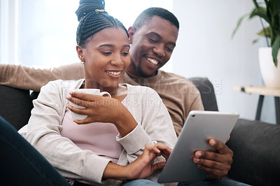 Buy stock photo Digital tablet, relax and black couple on a sofa scrolling on social media, mobile app or the internet. Happy, smile and African man and woman reading messages together on a device in the living room