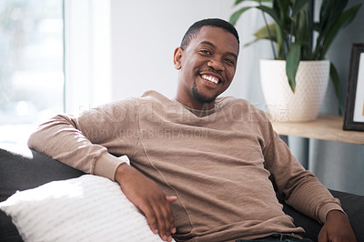 Buy stock photo Relax, smile and portrait of black man on sofa at home in city apartment. Happy, healthy and proud man and leader in business from South Africa smiling and relaxing alone on couch in living room.