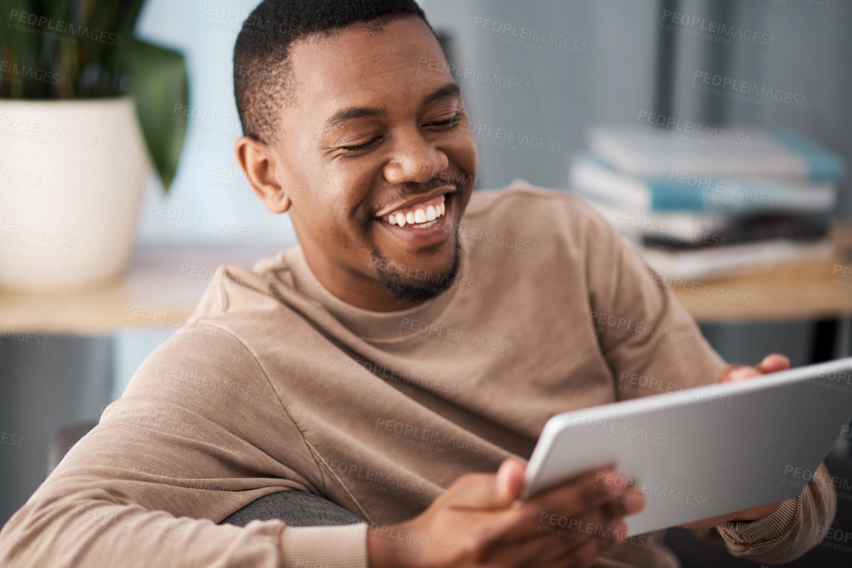 Buy stock photo Black man, tablet and happiness of a person on a living room sofa with technology online. Social media content, video streaming or meme of a man smile on a house couch on wifi and web at home