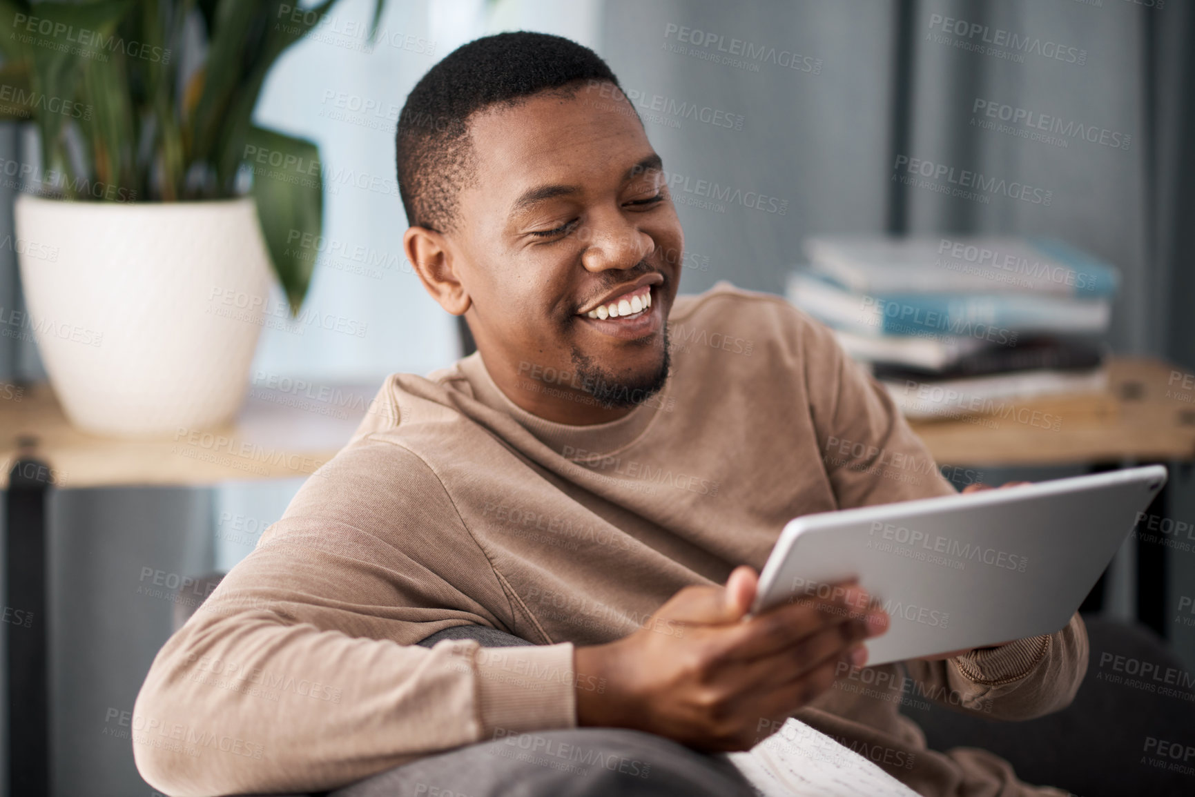 Buy stock photo Black man, tablet and smile in entertainment on sofa for online streaming, wifi or fast speed connection at home. Happy African American male holding touchscreen smiling and enjoying movies on couch