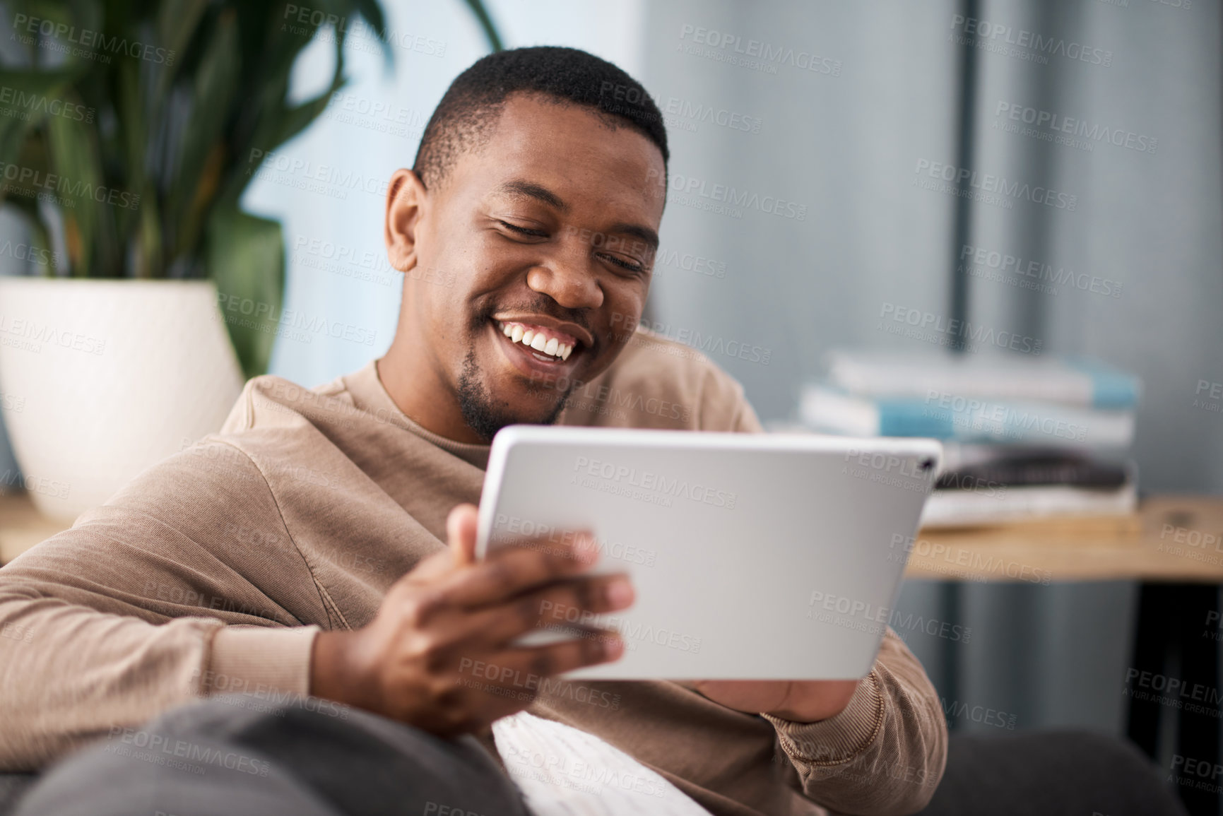 Buy stock photo Tablet, happy or black man on social media to relax or enjoy comedy movies or funny meme online at home. Subscription, ui or laughing African user watching or streaming comic digital content on sofa