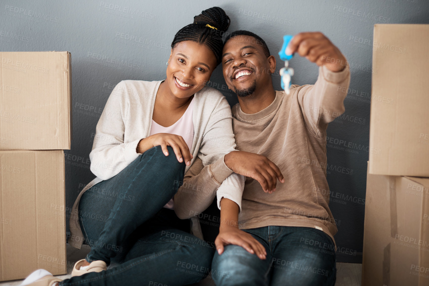 Buy stock photo Real estate, property and African couple with keys to their new home, excited and moving. Home owner, happy and portrait of black man and woman show house keys with a smile, boxes and in an apartment