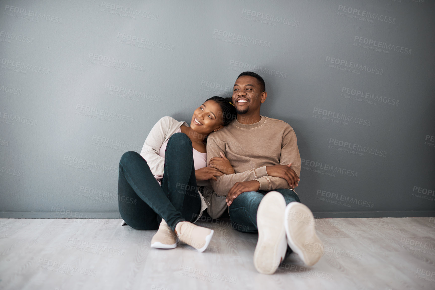 Buy stock photo Apartment, love and couple on floor with wall background relax, rest and bond after moving in new home together. Real estate, dating and young black couple in living room thinking of house design