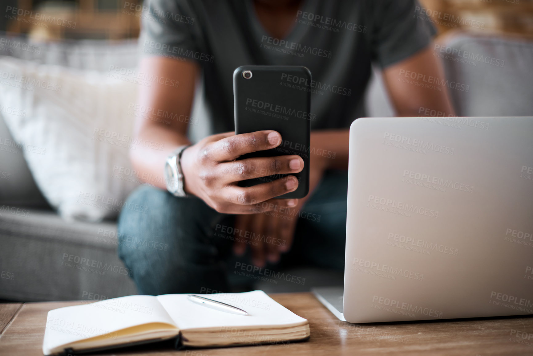 Buy stock photo Hands, phone and man with laptop planning on sofa in communication or texting with technology at home. Hand of student chatting on mobile phone, studying or working remote on project in living room