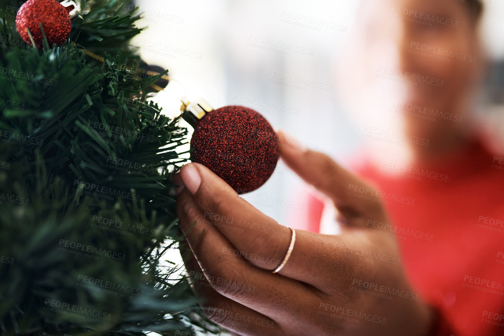 Buy stock photo Hand, decoration with Christmas ornament and tree, holiday celebration zoom with festive tradition. Red, glitter sphere for Christmas tree with decorating closeup and celebrate with bauble at home