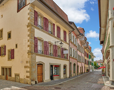 Buy stock photo Street view of old buildings in a historic city with built medieval architecture and a cloudy blue sky in Annecy, France. Beautiful landscape of an empty small urban town with homes or houses