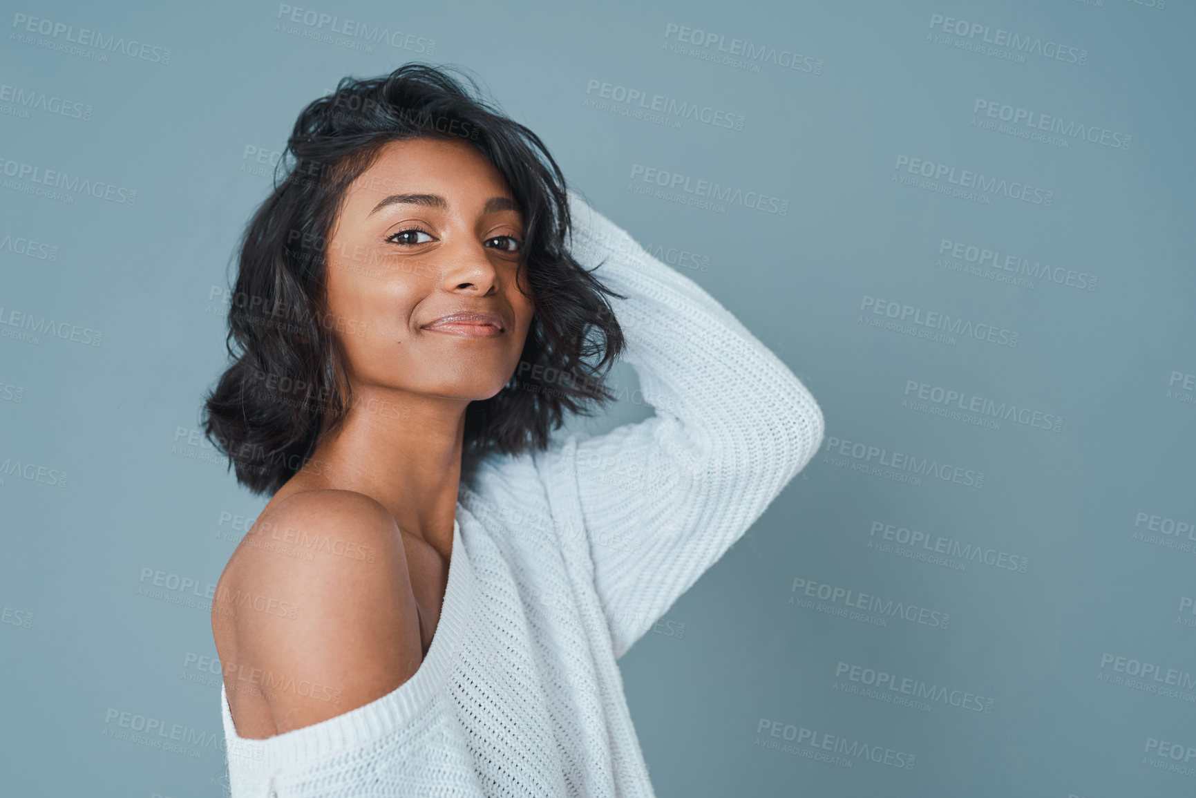 Buy stock photo Cropped shot of a beautiful young woman posing against a teal background