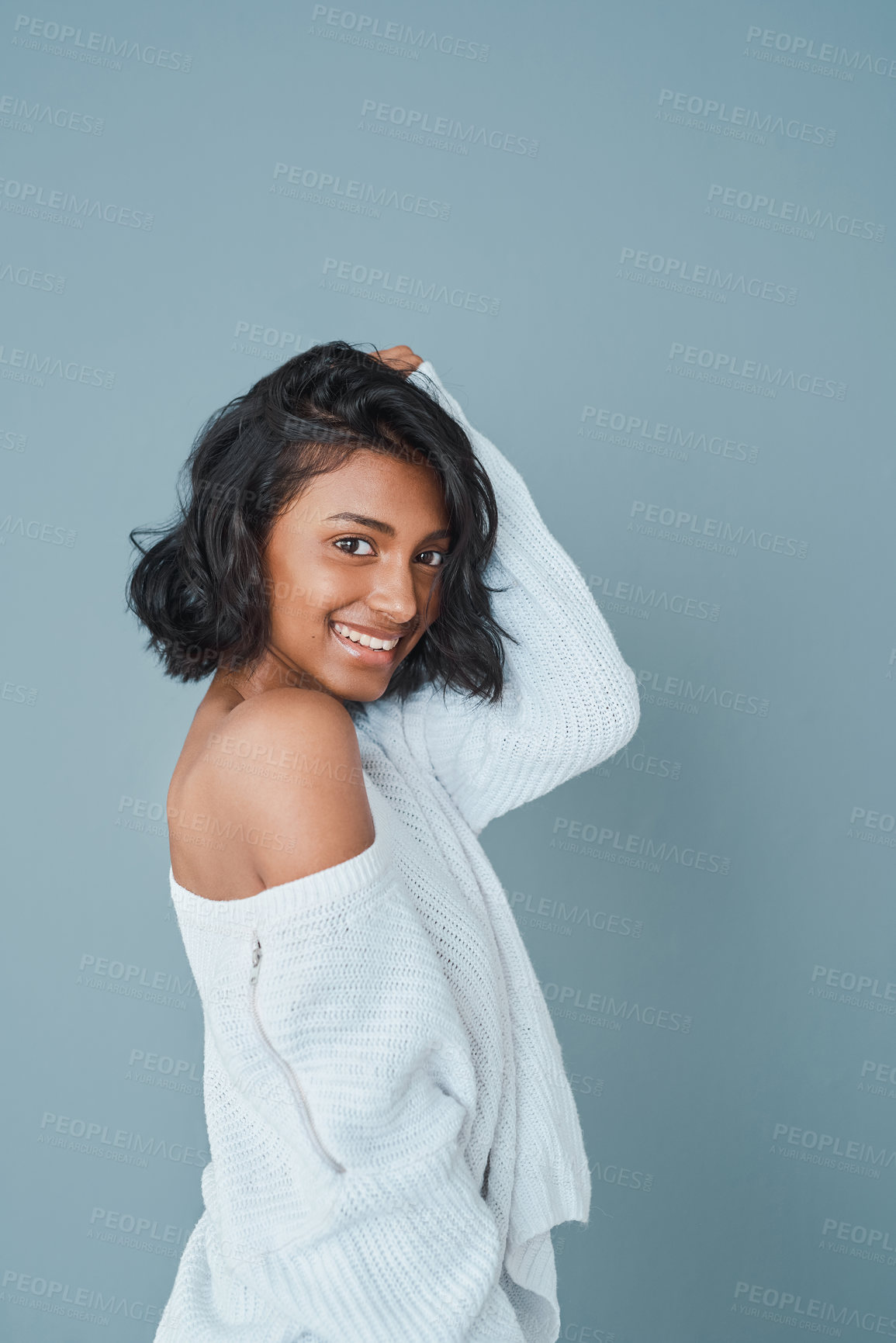 Buy stock photo Portrait, hair care and happy Indian woman with beauty, texture or trendy clothes on blue studio background. Face, cosmetics and confident model with hairstyle for growth, makeup or fashion aesthetic