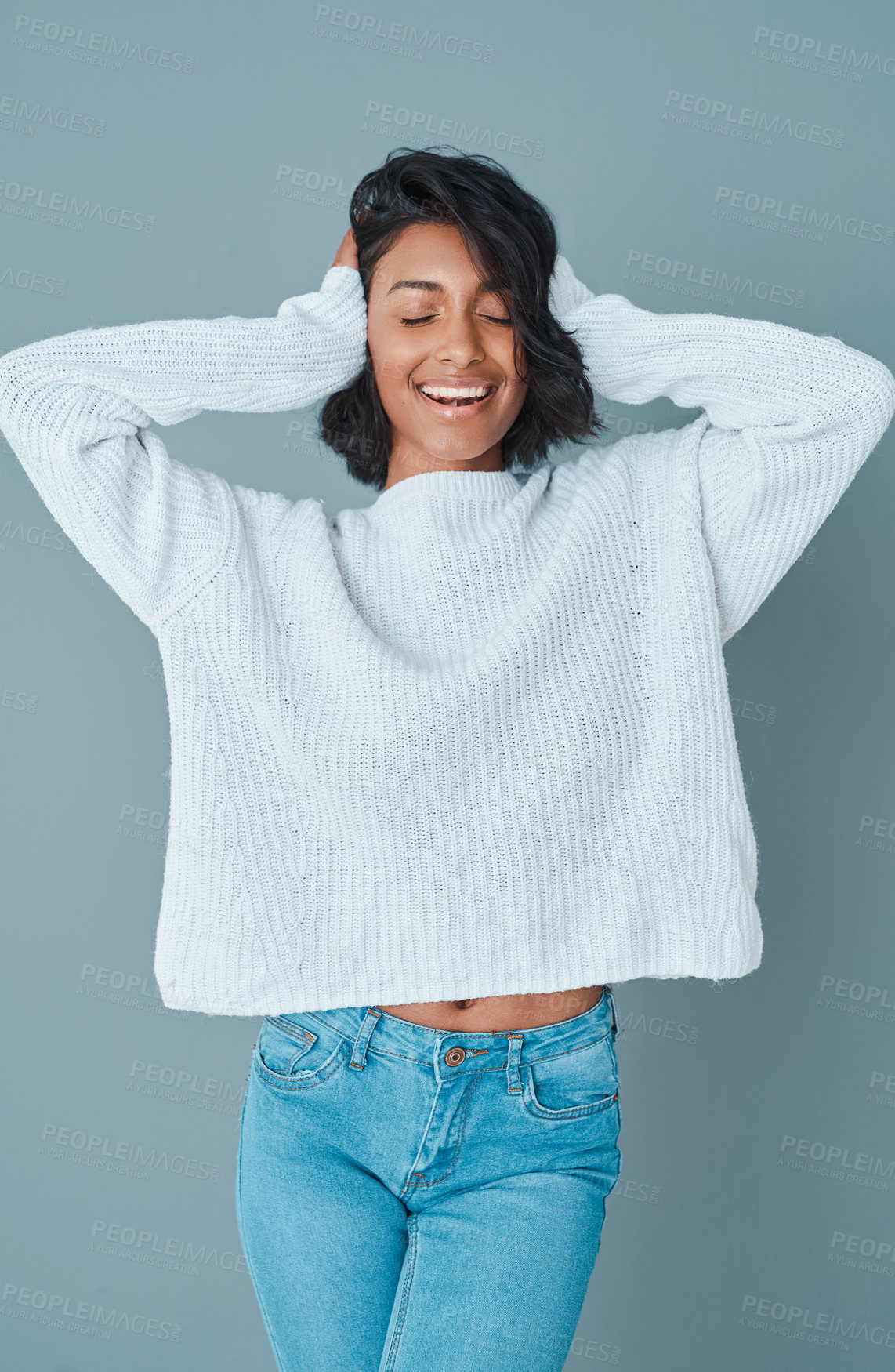 Buy stock photo Woman, smile and studio with winter fashion for eco friendly fabric, comfortable jersey or sustainability clothing. Model, happy and cozy with upcycling material and confident on gray background