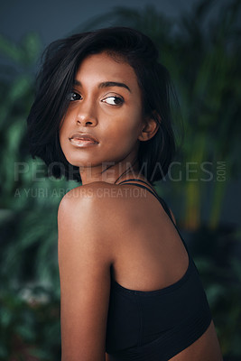 Buy stock photo Shot of a beautiful young woman posing against a dark background