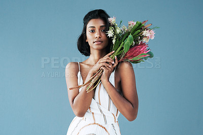 Buy stock photo Cropped shot of a beautiful young woman posing with a bouquet of flowers
