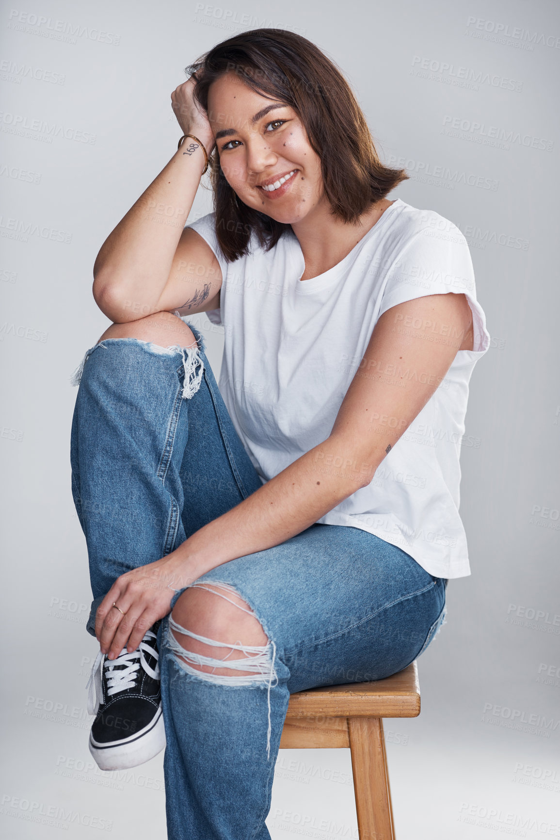 Buy stock photo Relax, happy and fashion with portrait of woman in studio for casual, trendy and calm. Asian, student and peace with person sitting on chair on white background for confidence, cool or clothes