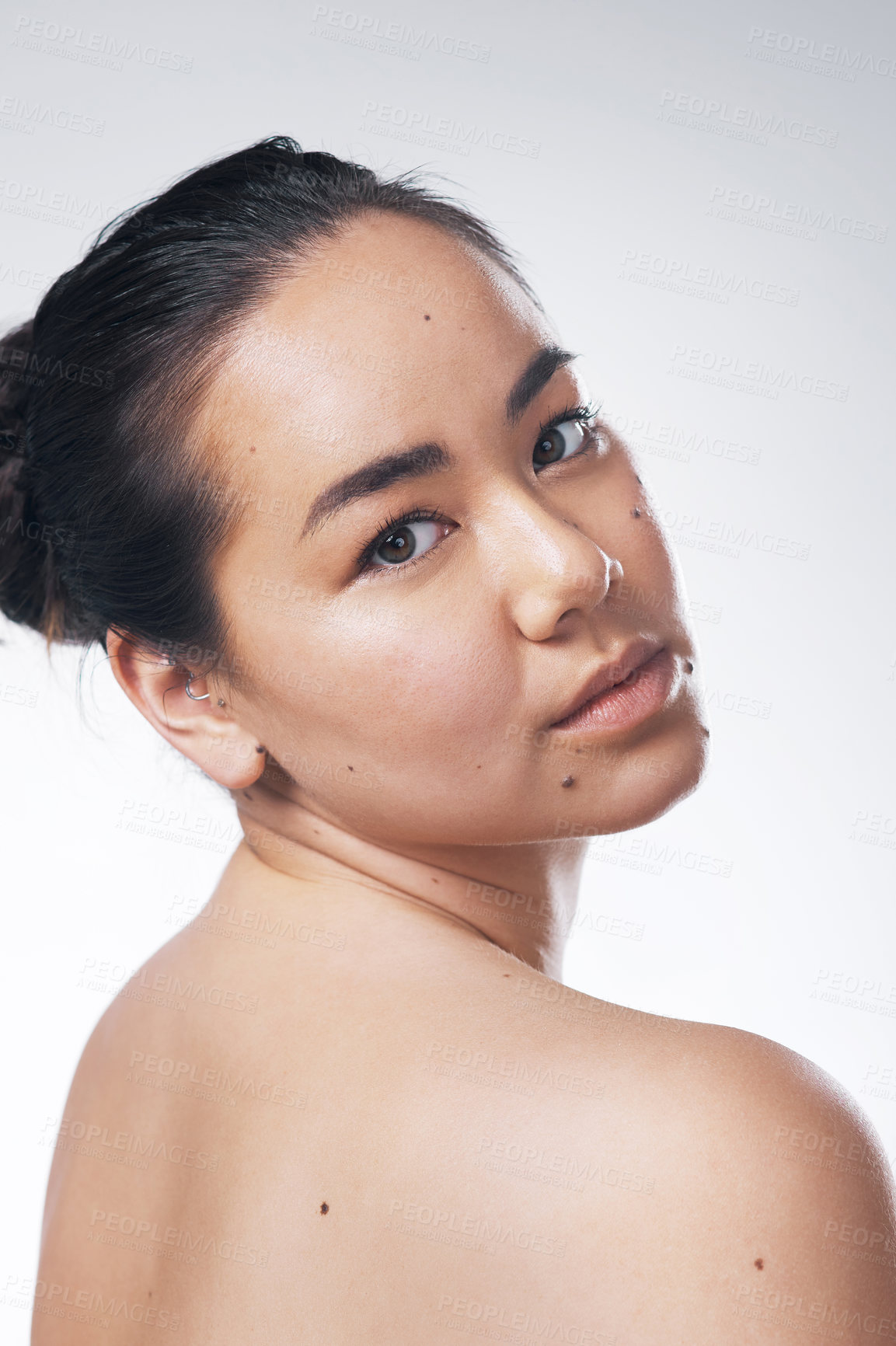 Buy stock photo Cropped shot of a beautiful young woman posing against a white background