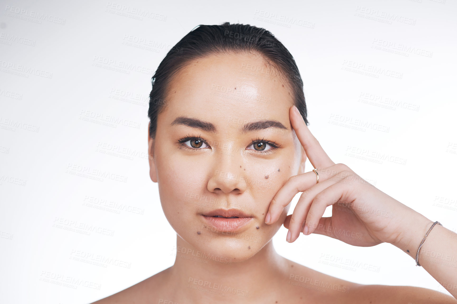 Buy stock photo Cropped shot of a beautiful young woman posing against a white background