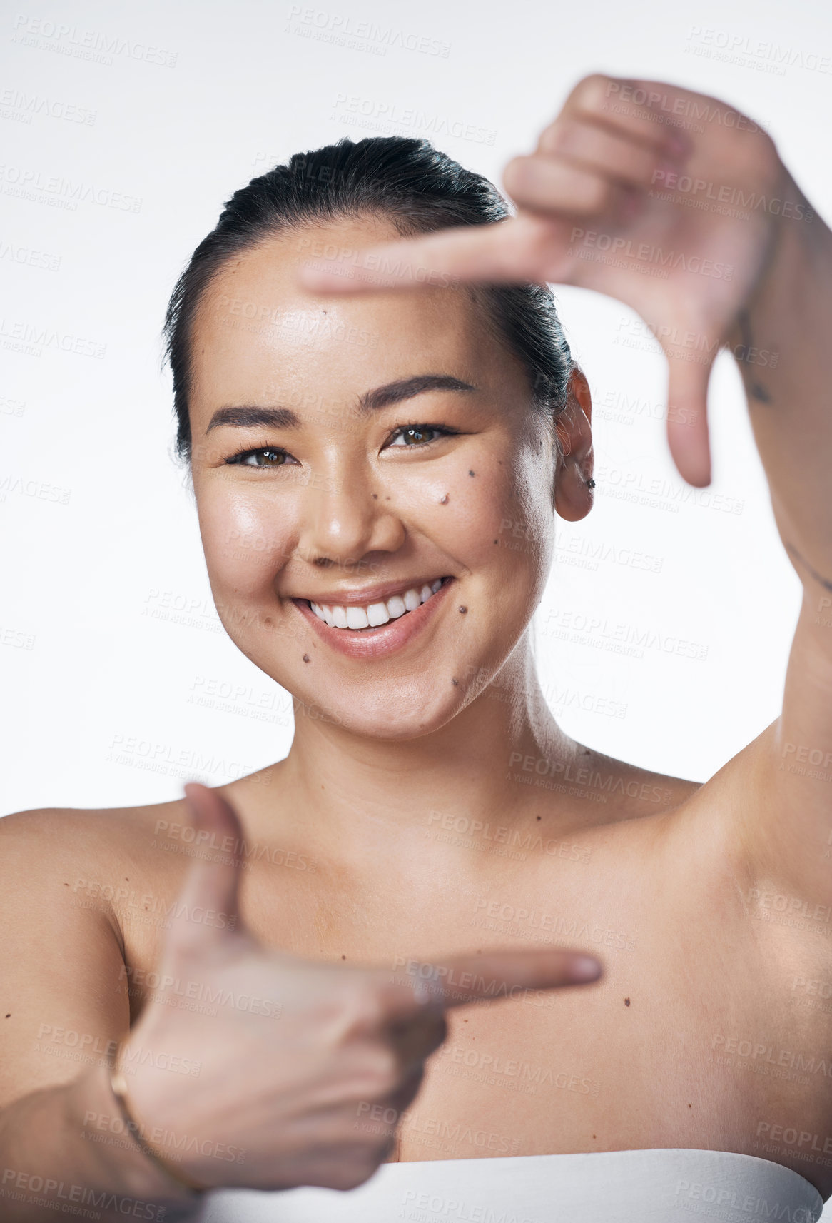 Buy stock photo Happy, portrait or asian woman with frame for skincare, beauty or salon treatment on a white studio background. Young, female person or model with smile, hand gesture or perspective for spa or memory