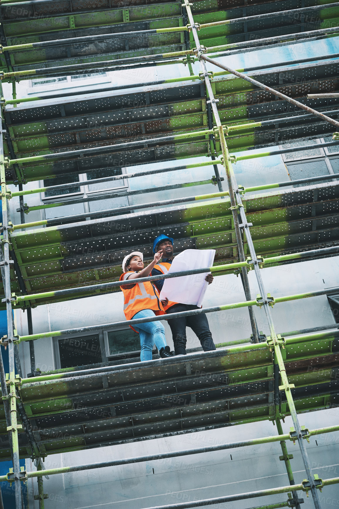 Buy stock photo Blueprint, man and woman on construction site with planning, collaboration and urban architecture. Ideas, discussion and contractor team on scaffolding for civil engineering, building and development