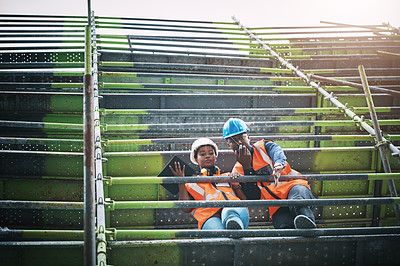 Buy stock photo Shot of a young man and woman working at a construction site