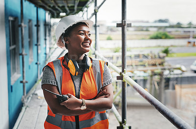 Buy stock photo A happy, smiling and cheerful young black woman or senior construction industry worker standing at a building site. A professional female employee working at housing or property development location