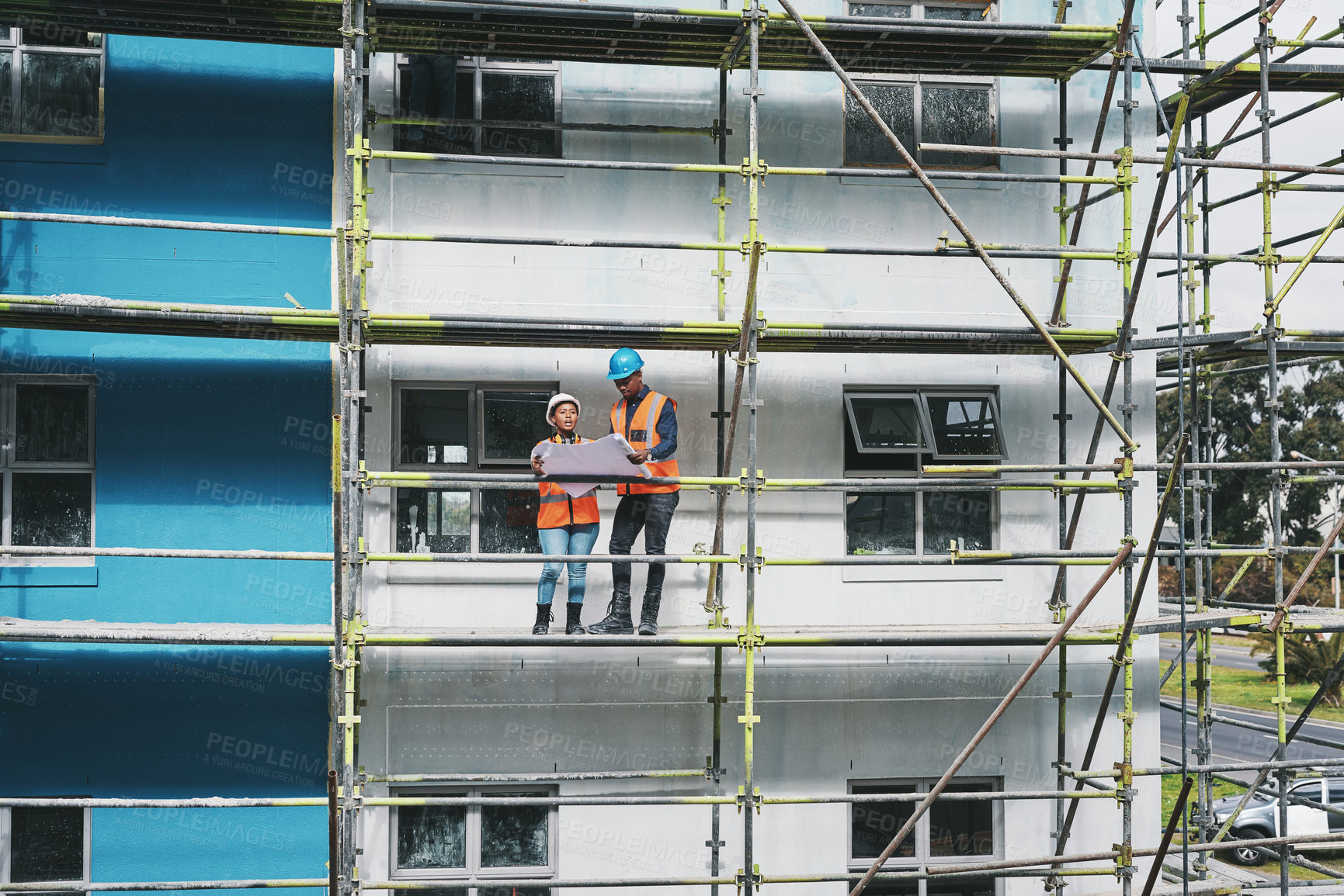 Buy stock photo Construction site, business people and blueprints for progress, scaffolding and planning with safety. Employees, man and woman with documents, teamwork and engineering with architecture and planning