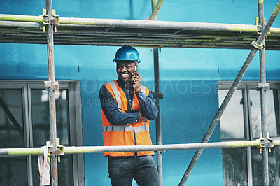 Buy stock photo Shot of a young man talking on a cellphone while working at a construction site