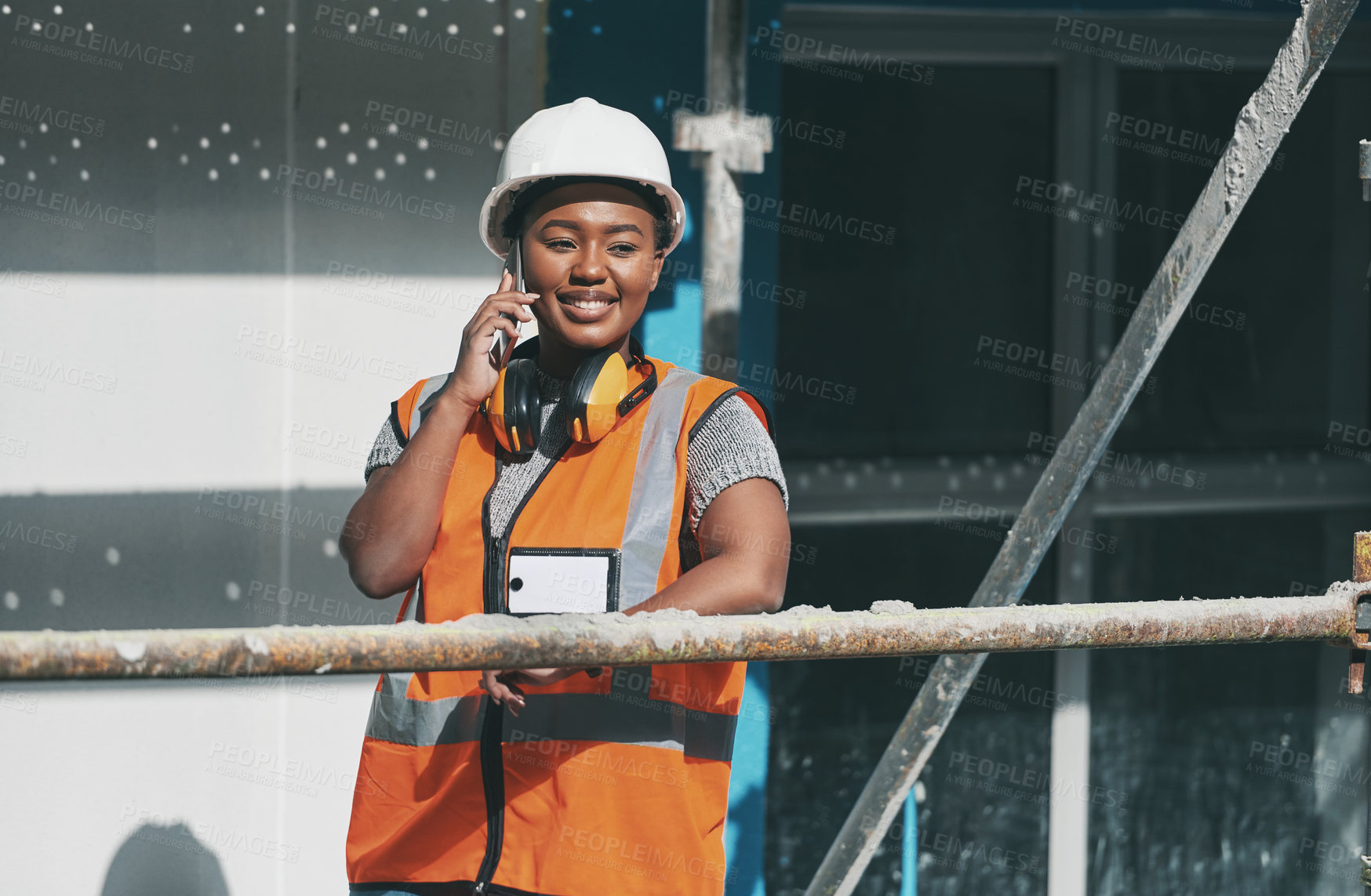 Buy stock photo Smile, phone call and black woman on construction site with building, communication and architecture. Developer, contractor or project manager at scaffolding on smartphone for civil engineering chat