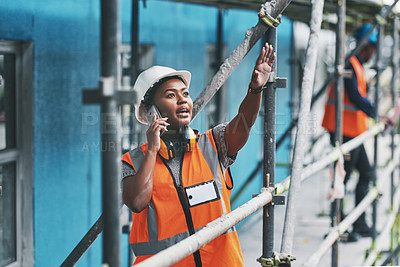 Buy stock photo Shot of a young woman talking on a cellphone while working at a construction site