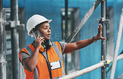 Buy stock photo Construction worker talking on a phone call while standing in an empty building. Professional builder discussing plans and strategy, checking the inside structure. Civil engineer doing a safety check