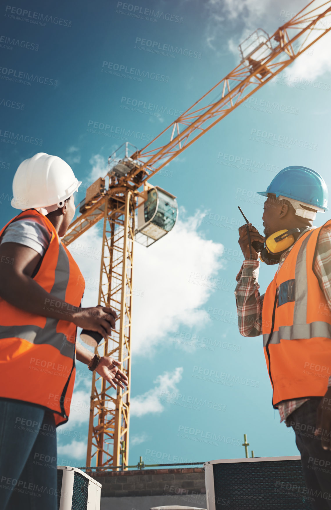 Buy stock photo Construction, engineering and team with walkie talkie and crane for building project, teamwork or architecture. Black woman and man manager together for engineer planning or safety inspection outdoor