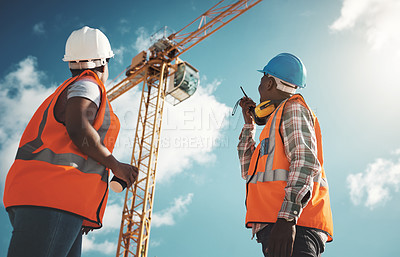 Buy stock photo Engineering, construction and team with walkie talkie and crane for building project, teamwork or communication. Black woman and man manager outdoor for engineer planning or safety inspection