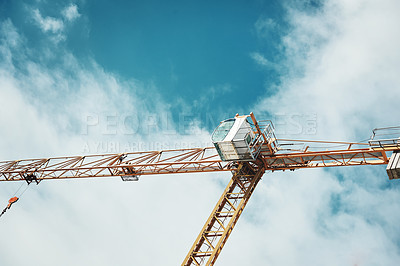 Buy stock photo Shot of a crane at a construction site