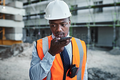 Buy stock photo Black man, architect and talking with speaker phone at site for communication or construction. Young African, civil engineer or builder with mobile smartphone for radio or voice note in an urban city