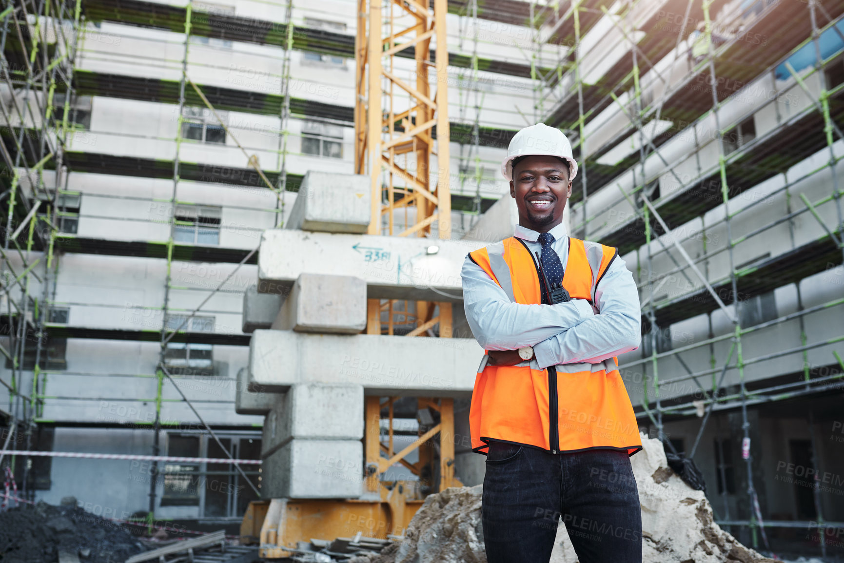 Buy stock photo Black man, portrait or civil engineer with confidence on site for construction, architecture or building in city. Young African, male person or contractor with arms crossed for industrial development