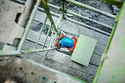 Buy stock photo Shot of a young woman climbing up a ladder at a construction site