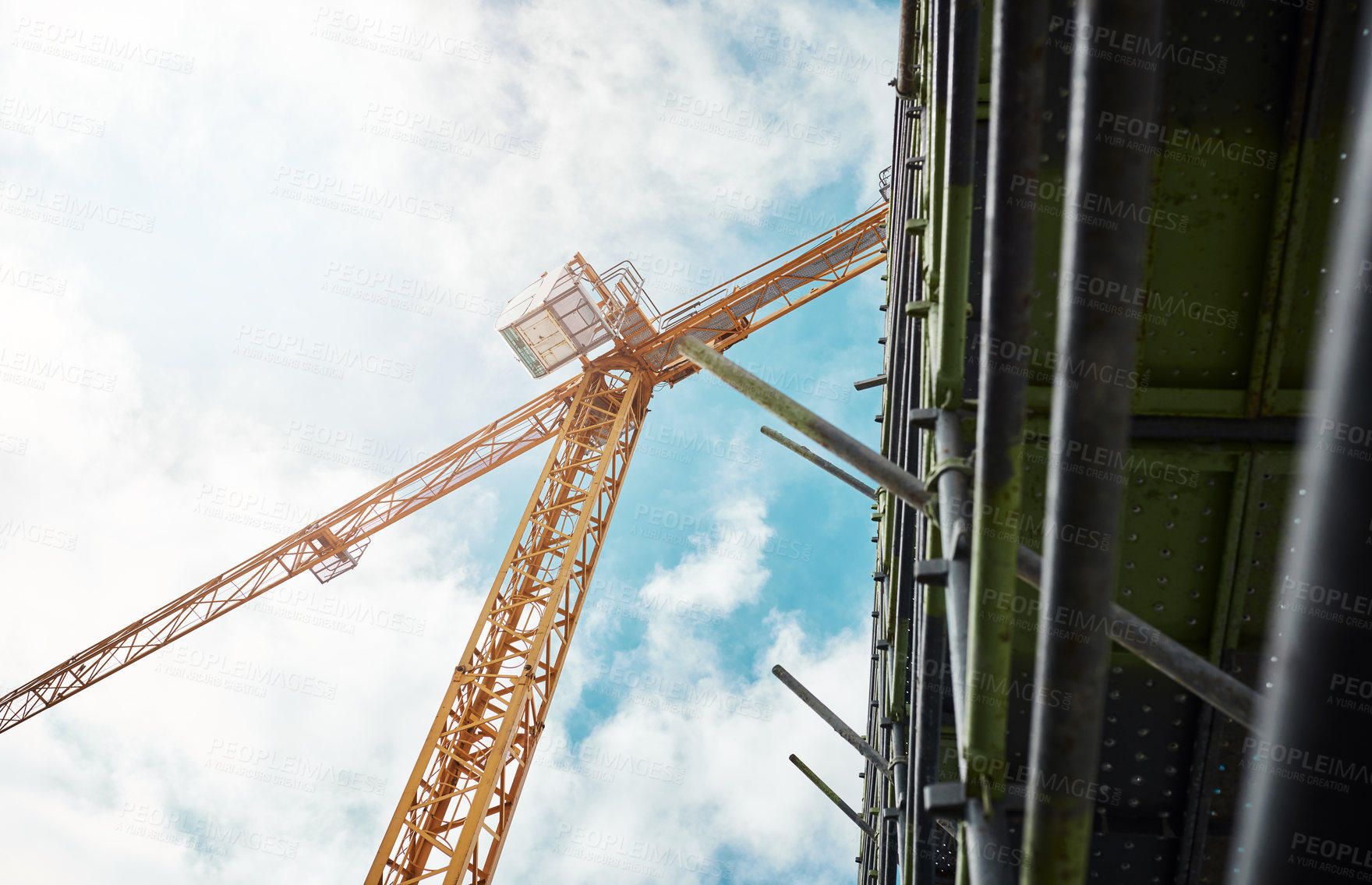 Buy stock photo Shot of a crane and building at a construction site