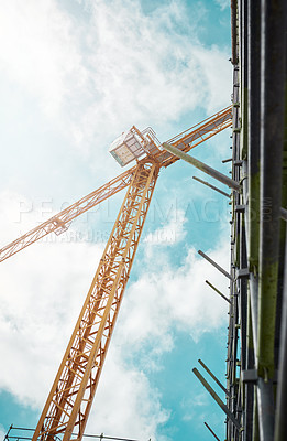 Buy stock photo Shot of a crane and building at a construction site