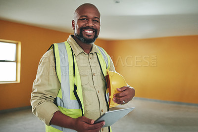 Buy stock photo Shot of a confident man using a digital tablet while working at a construction site