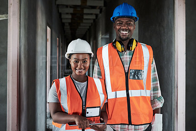 Buy stock photo Shot of a young man and woman using a digital tablet while working at a construction site