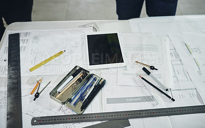 Buy stock photo Shot of various tools and a blueprint on a table at a construction site