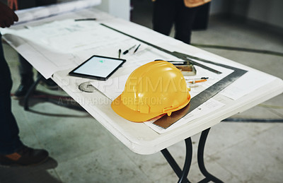Buy stock photo Shot of various tools and a blueprint on a table at a construction site